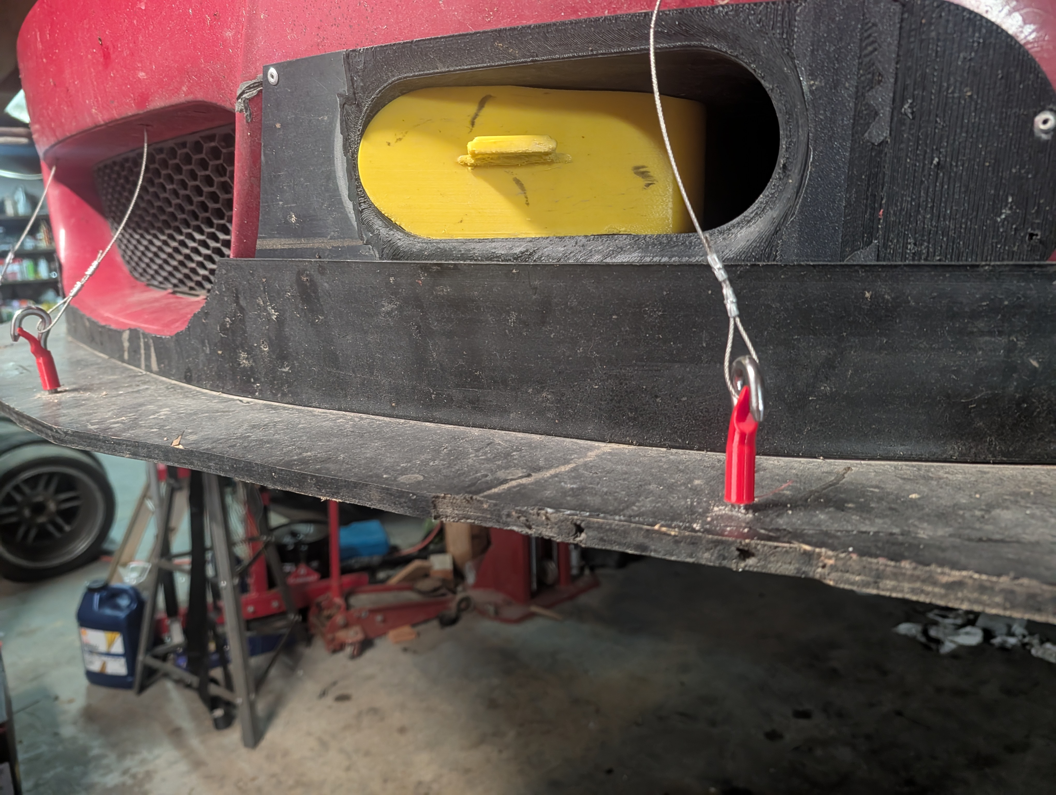 Bumper overlay installed in the car with the yellow plug in the oval port