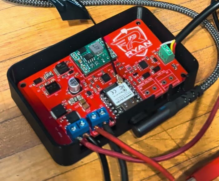 Red Rev E methanol controller board in a black printed case with the XIAO module, buck module and blue terminals