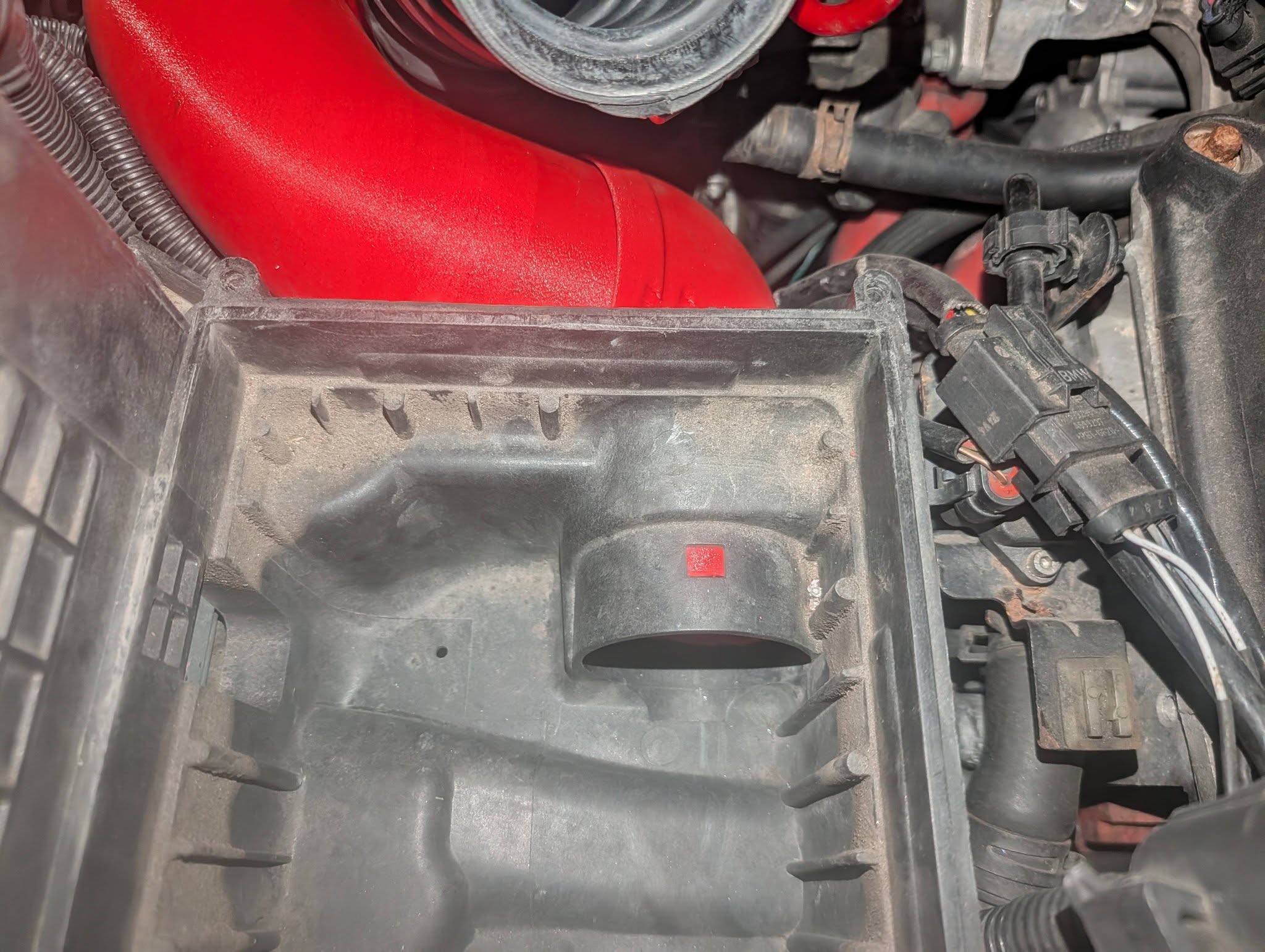 Early black airbox installed with red intake tube