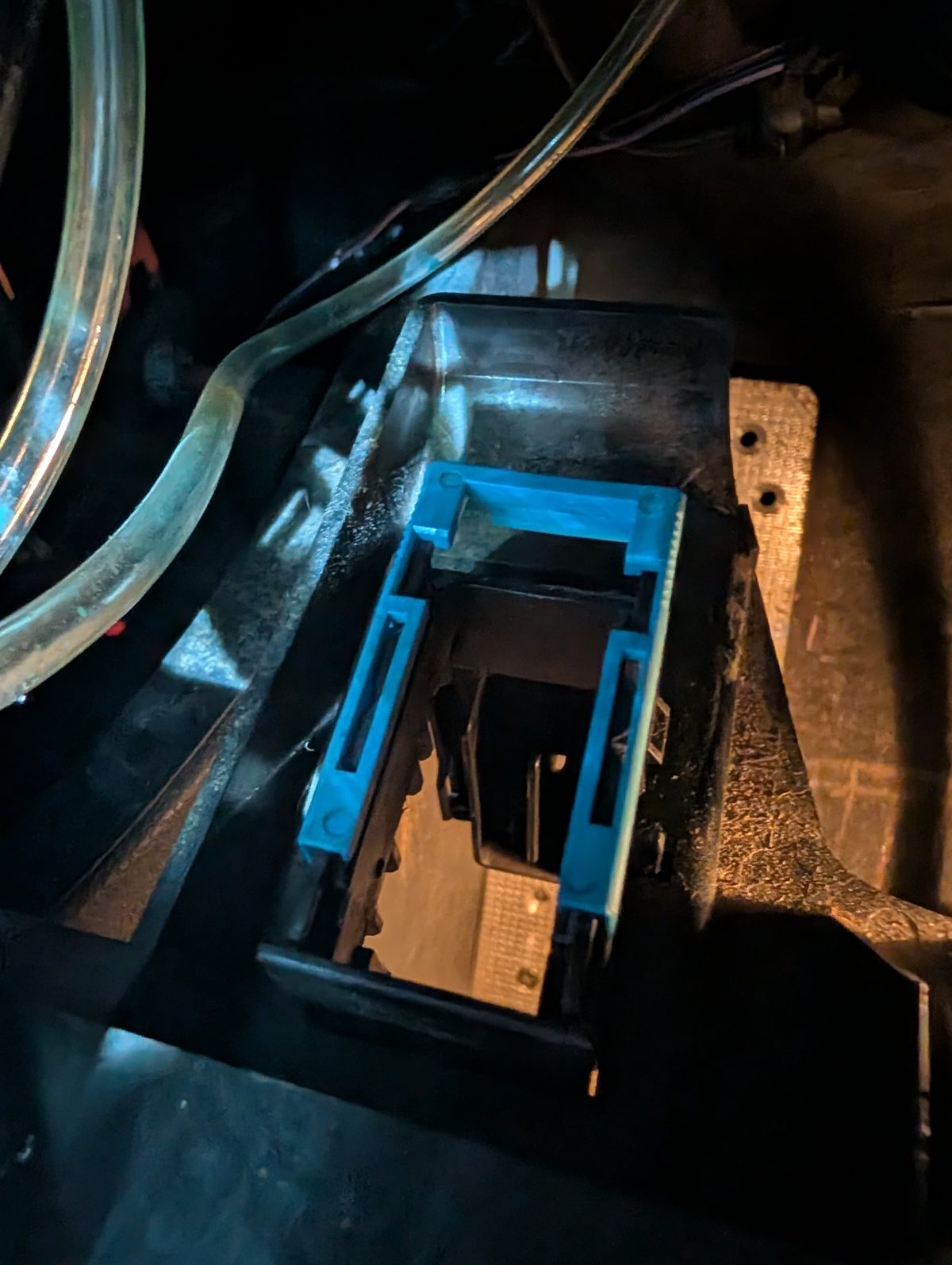 The OBD socket's mount under the dash with the socket unclipped
